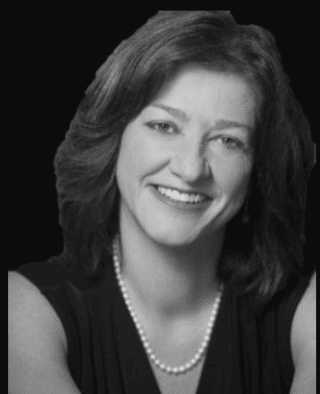 Black-and-white portrait of smiling woman with pearls